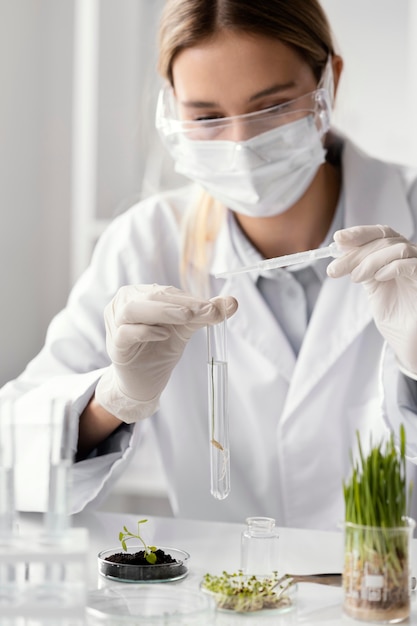 Free photo close up scientist working with tube