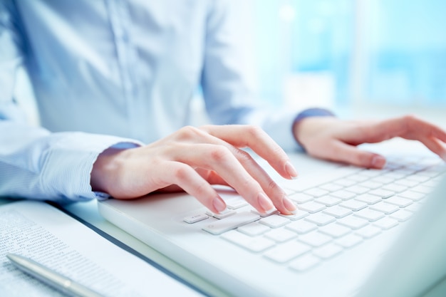 Close-up of secretary typing on the keyboard