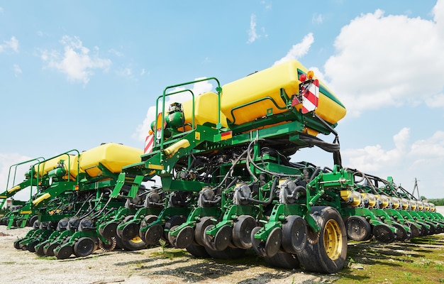 Free photo close up of seeder attached to tractor in field.