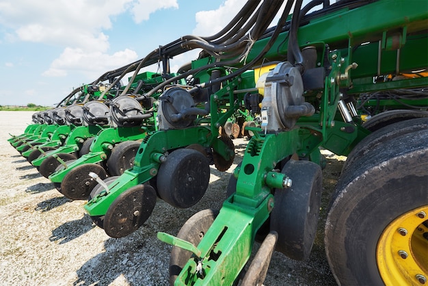 Free Photo close up of seeder attached to tractor in field.