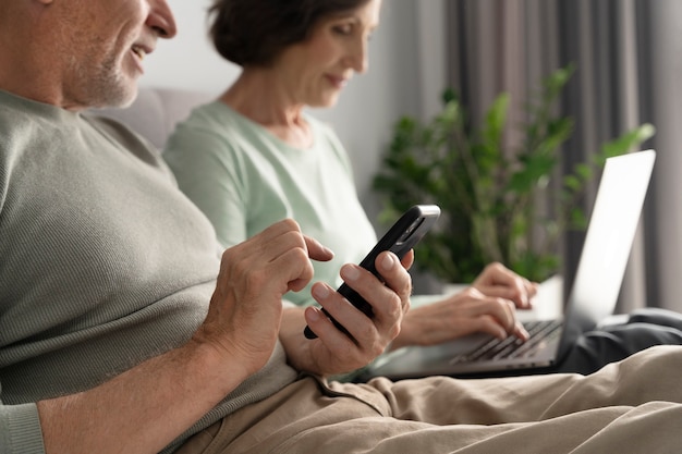 Close up senior couple with devices