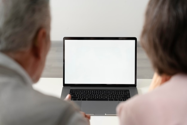 Close up senior couple with laptop