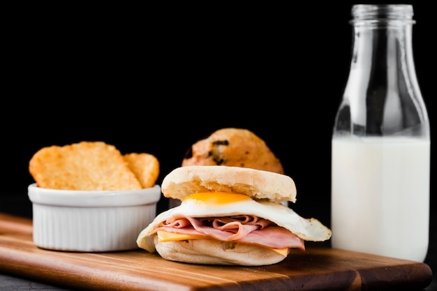 Free Photo close-up set benedict egg sandwich next to milk bottle