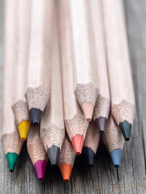 Close-up set of colored pencils for drawing on blurred background.