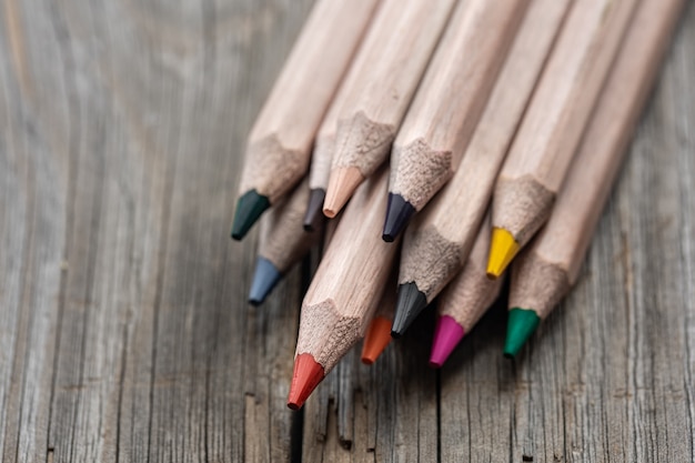 Close-up set of colored pencils for drawing on blurred background.