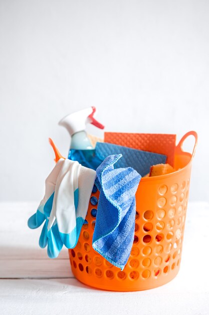 Close up set of home cleaning products in a bright basket. Means for maintaining cleanliness.