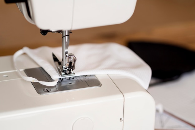 Free photo close-up of sewing machines with face mask