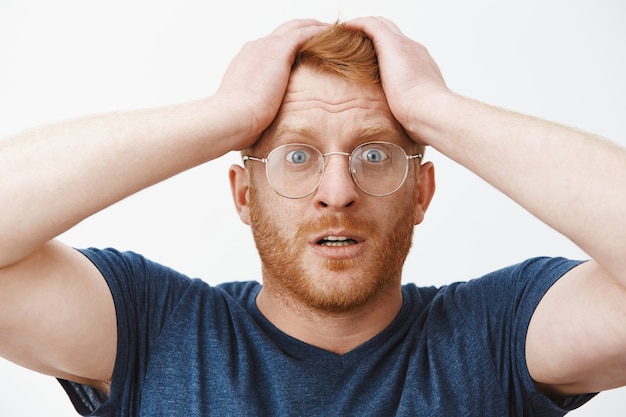 Free Photo close-up of shocked alarmed redhead man slap forehead and panicking, forgot something