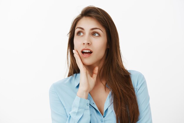 Close-up shot of charming brunette businesswoman posing in the studio