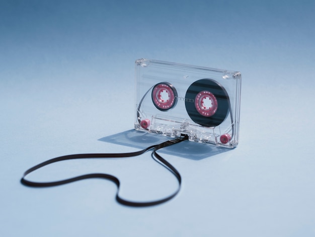 Free Photo close-up shot clear cassette tape on gradient background