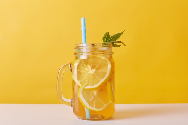 Close up shot of fresh drink with lemons and mint