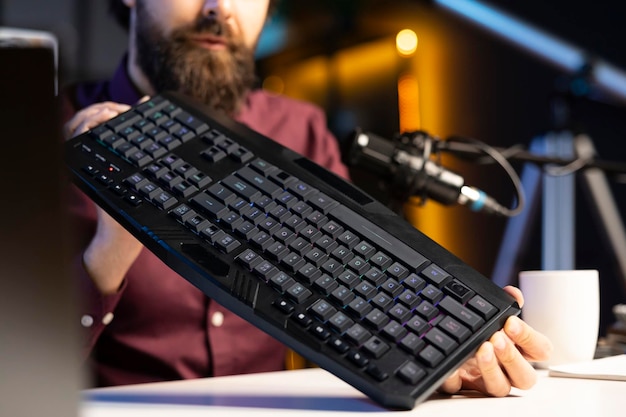 Free photo close up shot of gaming keyboard reviewed by influencer in studio