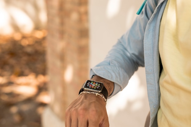 Free Photo close-up shot of a man checking his smartwatch