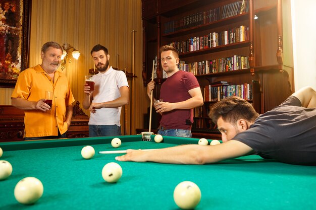 Close-up shot of a man playing billiard.