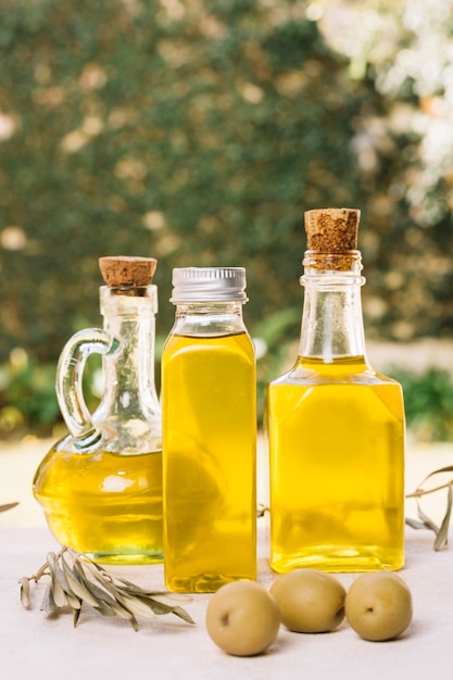 Free photo close-up shot olive oil bottles in sunlight