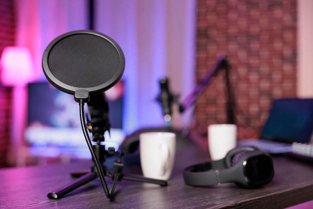 Free Photo close up shot of podcast microphone used to record internet show for online livestreaming channel. streaming sound capturing and recording podcasting tool in empty living room with neon lights