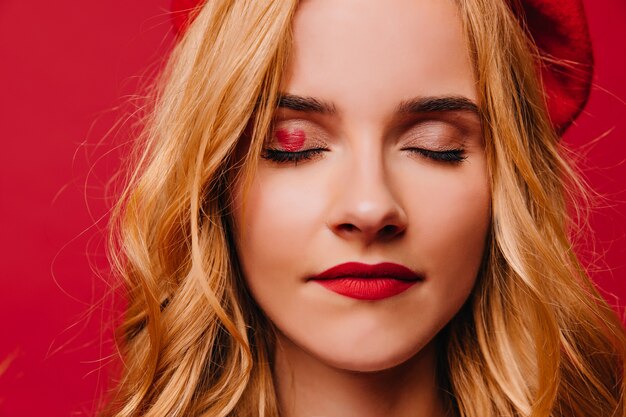 Close-up shot of relaxed beautiful woman in beret.