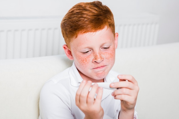 Free photo close up sick boy with fever