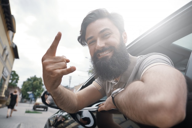 Close up side portrait of happy man driving car