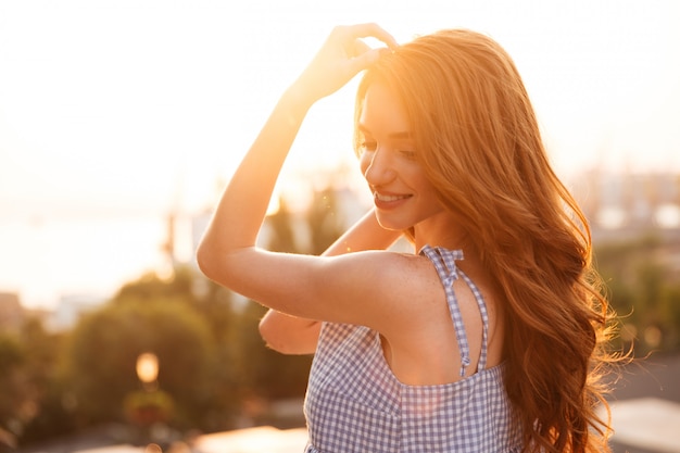 Close up side view of ginger woman in dress