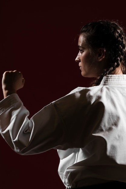 Free photo close-up sideways woman in white karate uniform