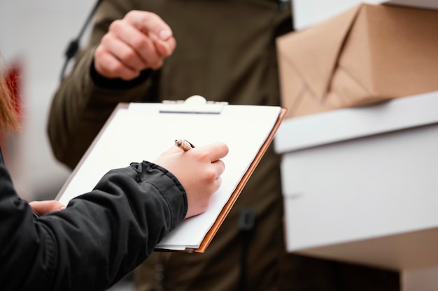 Close up signing for package delivery