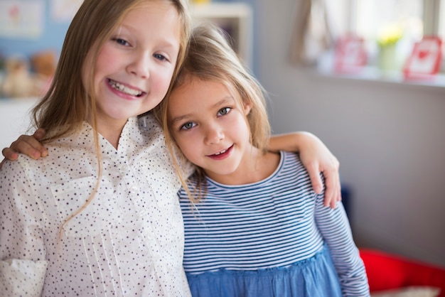 Close up of sisters embracing each other