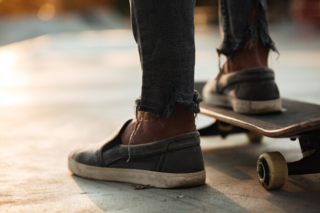 Close up of skateboarders feet skating