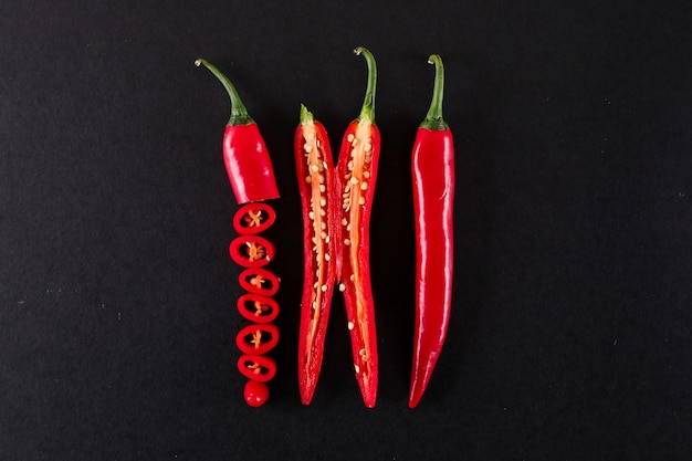 close up sliced red chili pepper isolated on black surface