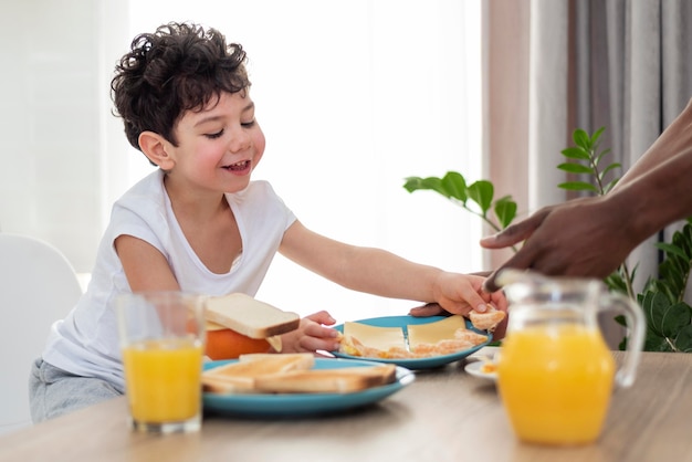 Close up on small boy eating tost for breakfast