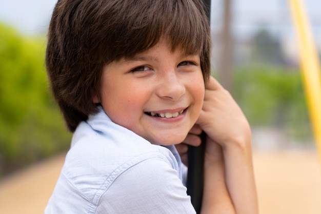 Close up smiley boy on swing