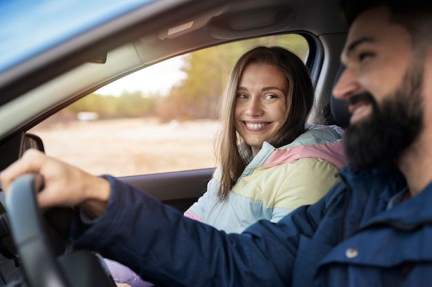 Close up smiley couple traveling by car