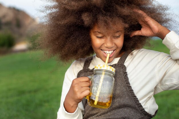 Close up smiley girl holding juice