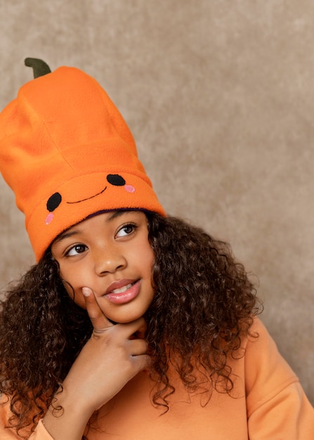 Close up smiley girl with pumpkin hat