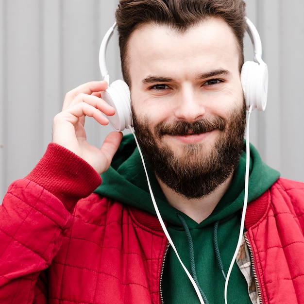 Close-up smiley guy with beard and headphones