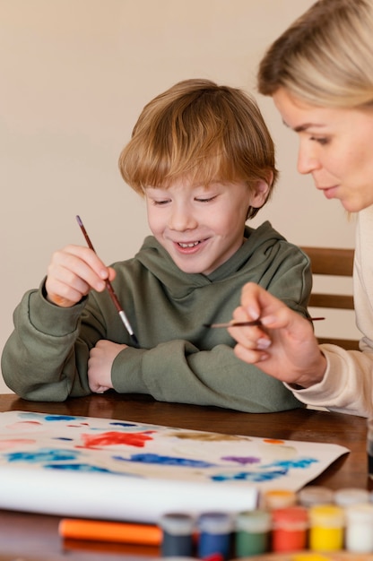 Close-up smiley kid painting