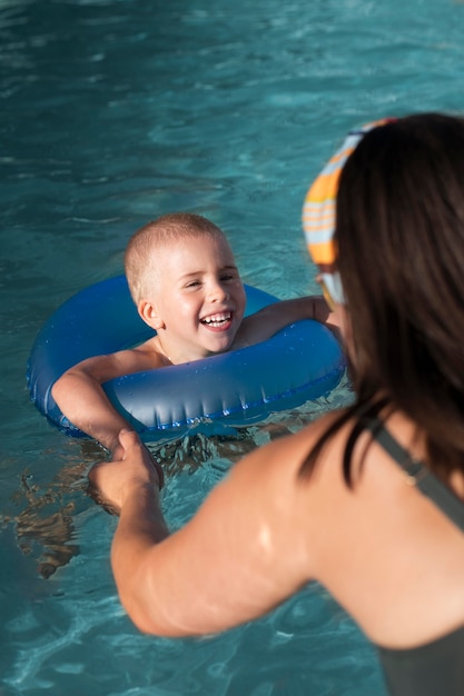 Free photo close up smiley kid with lifebuoy