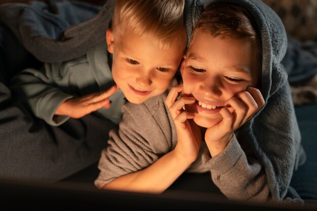 Close up smiley kids with laptop