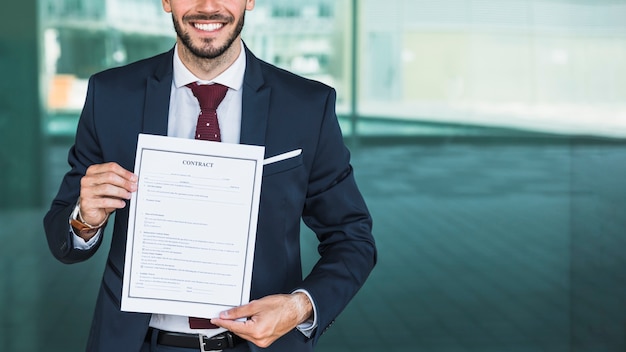 Free photo close-up smiley lawyer holding a contract