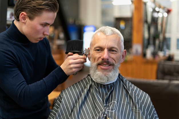 Close up smiley man getting groomed