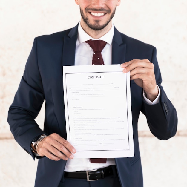 Close-up smiley man holding a contract