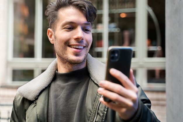 Close up smiley man holding device