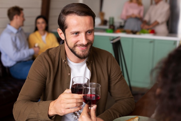 Close up smiley man holding wine glass