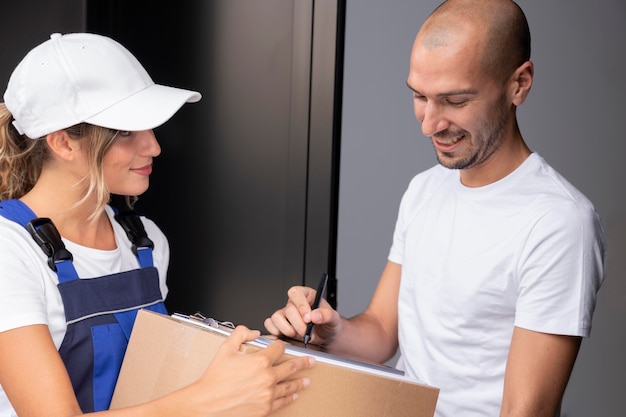 Free photo close up smiley man receiving pack