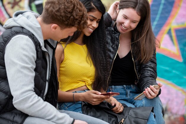 Close up smiley teenagers with phones