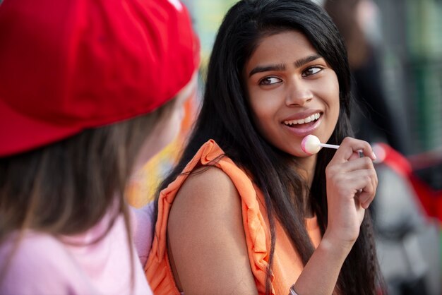 Close up smiley teens with lollipop