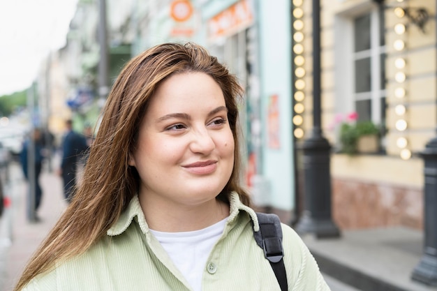 Free photo close up smiley woman in city