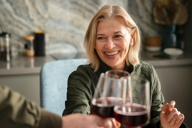 Free Photo close up smiley woman holding glass