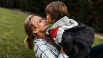 Free photo close-up smiley woman holding kid