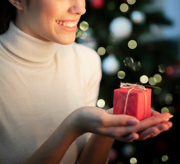 Free Photo close-up smiley woman holding small gift